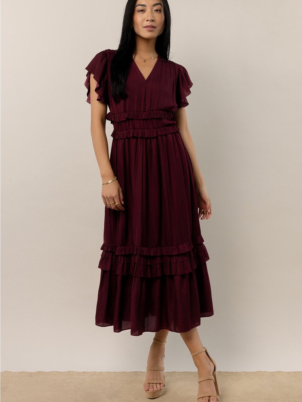 Bohme Maroon Ruffle Willa Midi Dress features a V-neckline and tiered skirt. L